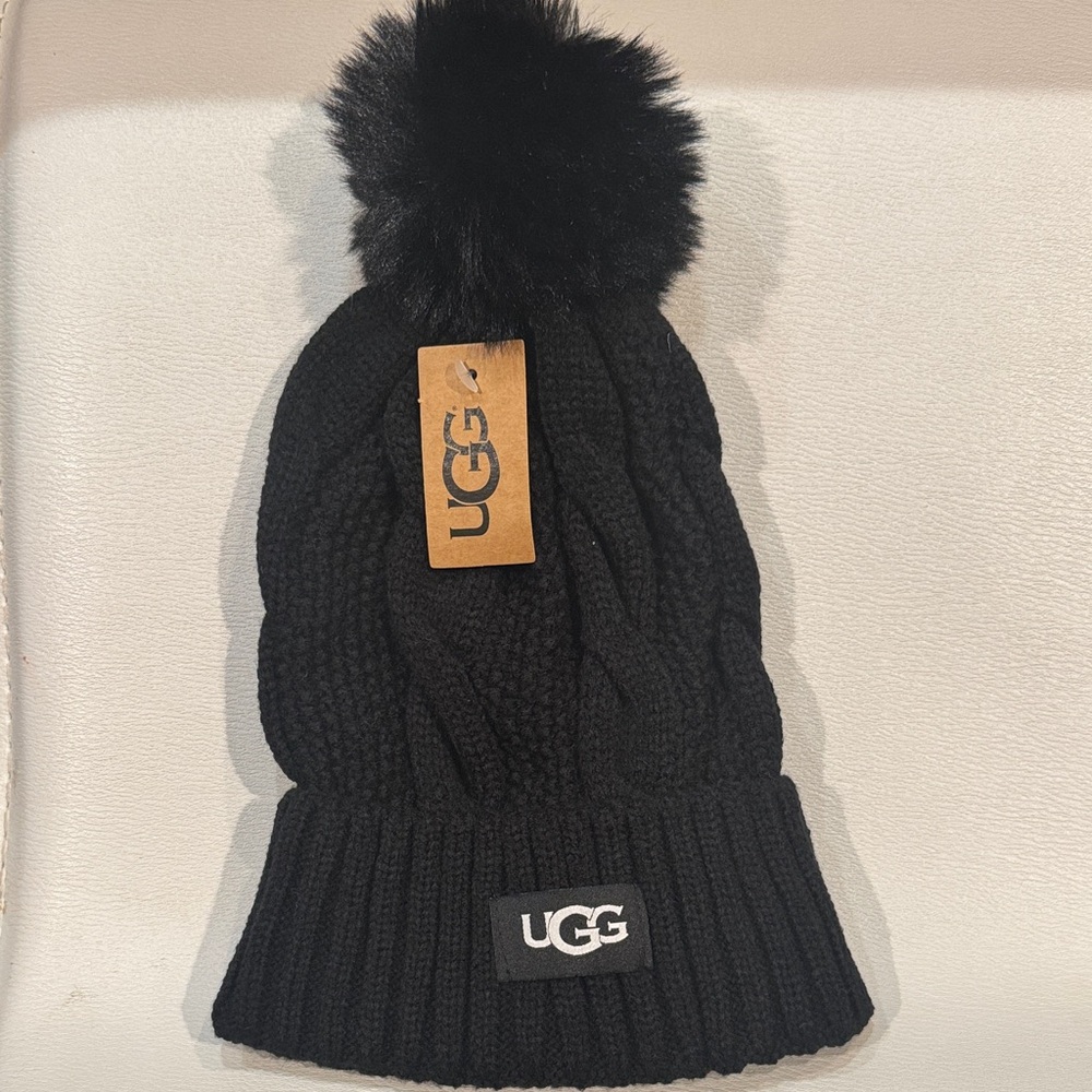 UGG NWT Accessories. Cable Knit Beanie with Faux Fur Pom. Color: Black